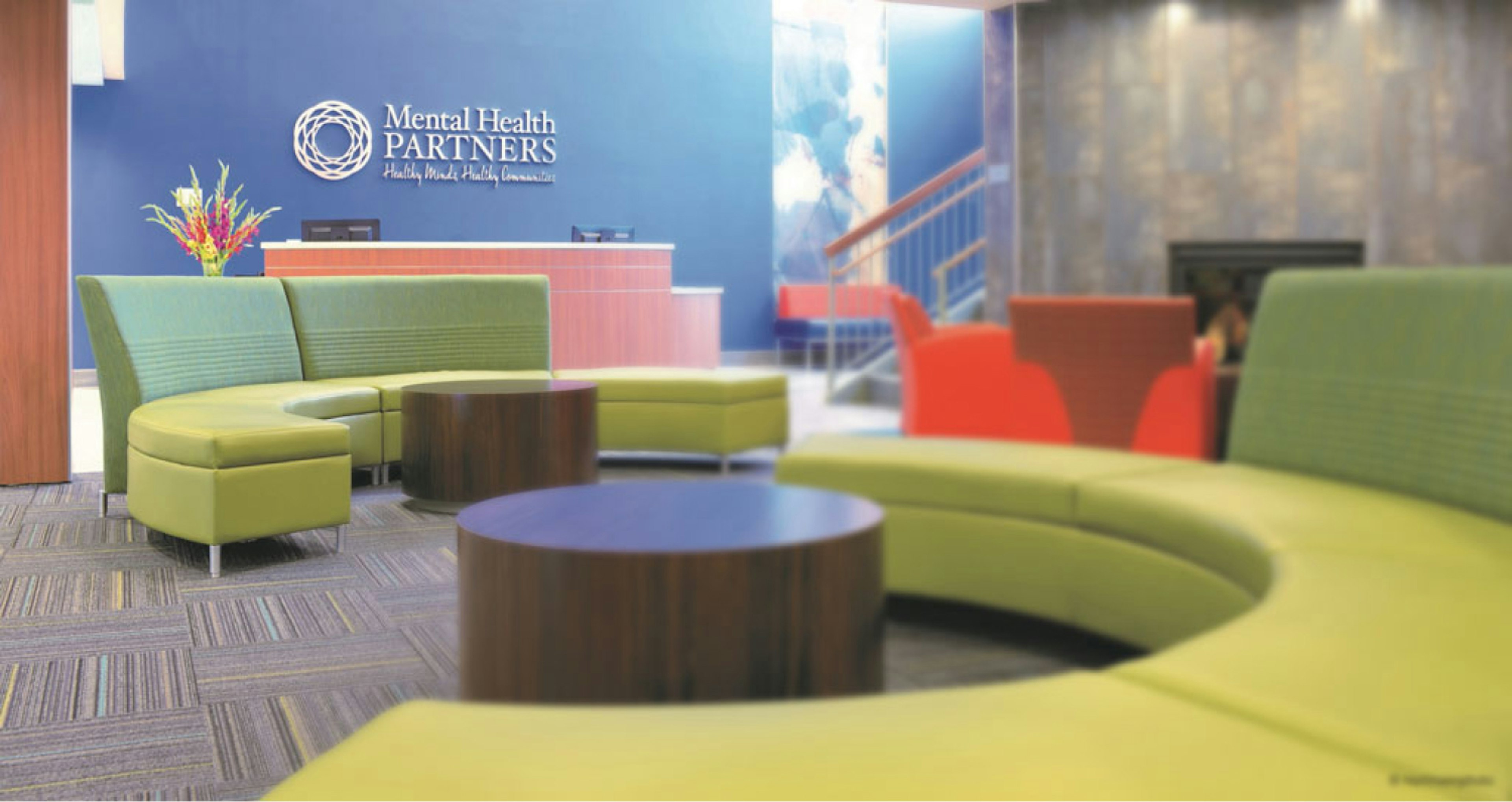 Ryan Wellness Center lobby photo featuring green lounge couches. 